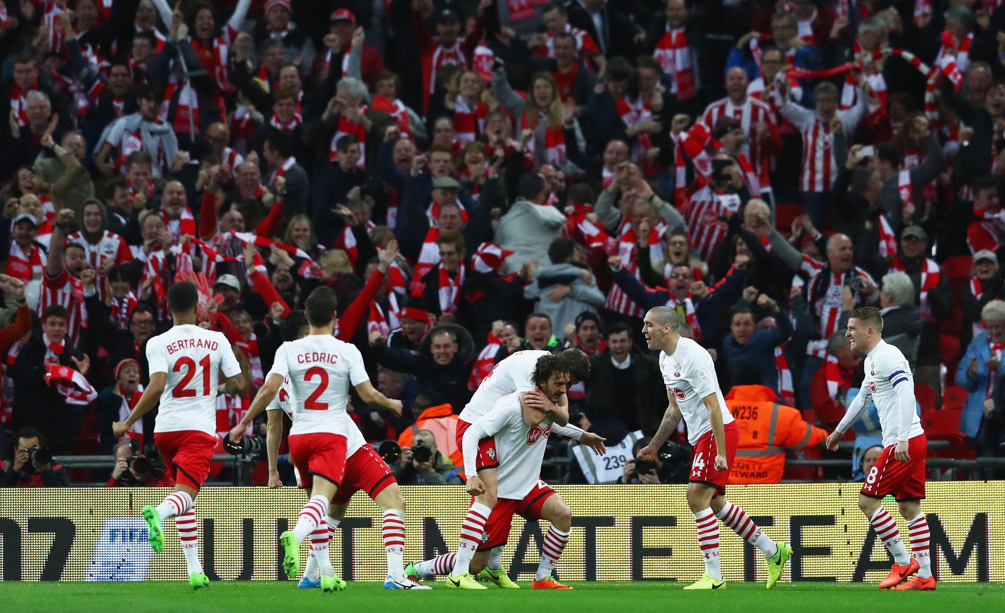 LONDON, ENGLAND - FEBRUARY 26: Manolo Gabbiadini of Southampton (3R) celebrates with team mates and fans as he scores their second goal during the EFL Cup Final match between Manchester United and Southampton at Wembley Stadium on February 26, 2017 in London, England. (Photo by Michael Steele/Getty Images)