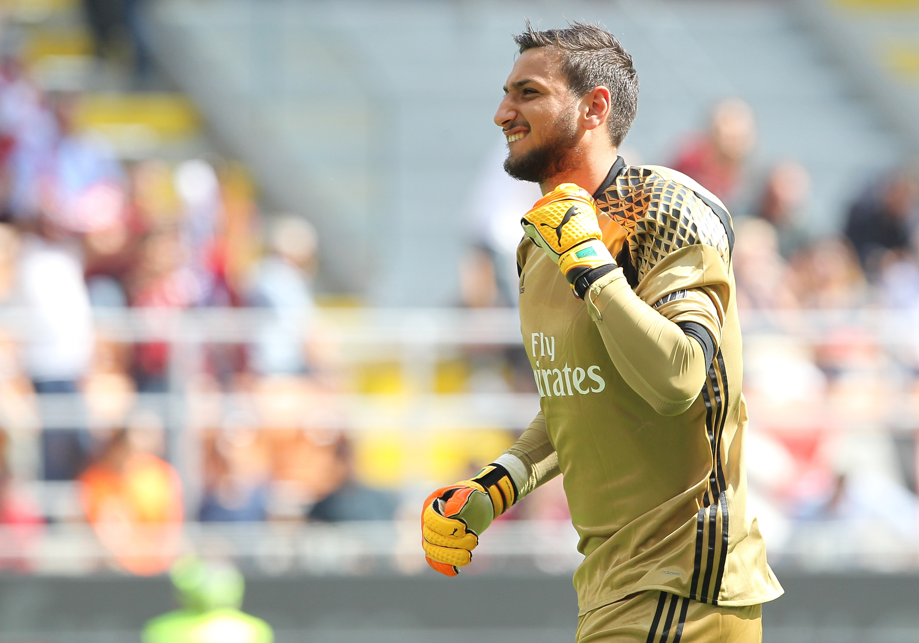 MILAN, ITALY - APRIL 09: Gianluigi Donnarumma of AC Milan celebrates his team-mates goal during the Serie A match between AC Milan and US Citta di Palermo at Stadio Giuseppe Meazza on April 9, 2017 in Milan, Italy. (Photo by Marco Luzzani/Getty Images)