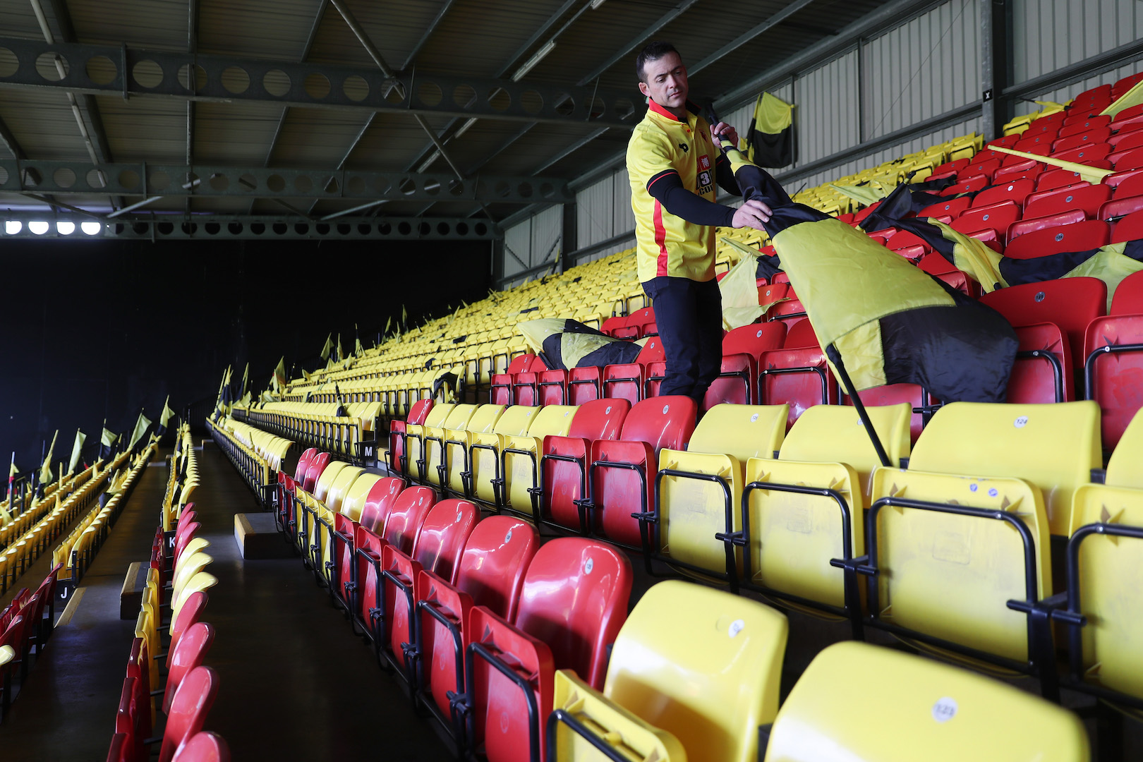 WATFORD, ENGLAND - APRIL 01: A Watford fan prepares a flag prior to the Premier League match between Watford and Sunderland at Vicarage Road on April 1, 2017 in Watford, England. (Photo by Christopher Lee/Getty Images)