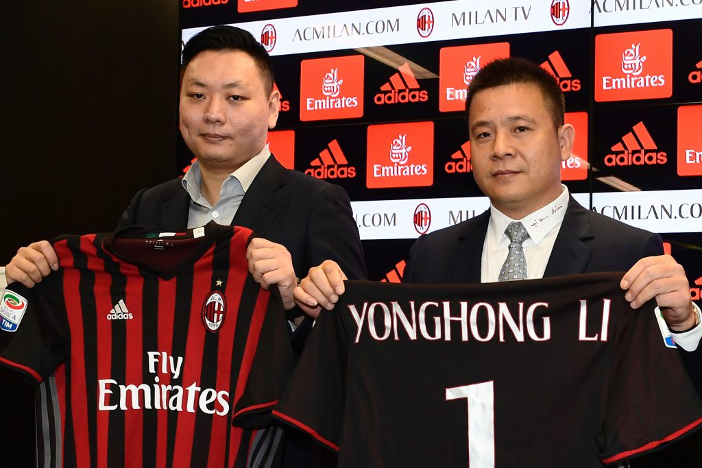 Head of Rossoneri Sport Investment Lux, Chinese businessman and new owner of the AC Milan football club, Yonghong Li (R) poses with Rossoneri Sport Investment Lux representative David Han Li (L) during a press conference on April 14, 2017 in Milan. Serie A giants AC Milan were sold to Rossoneri Sport Investment Lux yesterday in a deal which sees the Chinese-led consortium take a 99.9% stake in the club. The seven-time European champions who are Italy's most succcessful club in international competition, have been owned by former three-time Italy prime minister Silvio Berlusconi since 1986. A joint statement by AC Milan's holding company Fininvest and Rossoneri Sport Investment Lux said on April 13, 2017 : "Today Fininvest has completed the sale of the entire stake owned in AC Milan - equal to 99.93% - to Rossoneri Sport Investment Lux." / AFP PHOTO / MIGUEL MEDINA (Photo credit should read MIGUEL MEDINA/AFP/Getty Images)