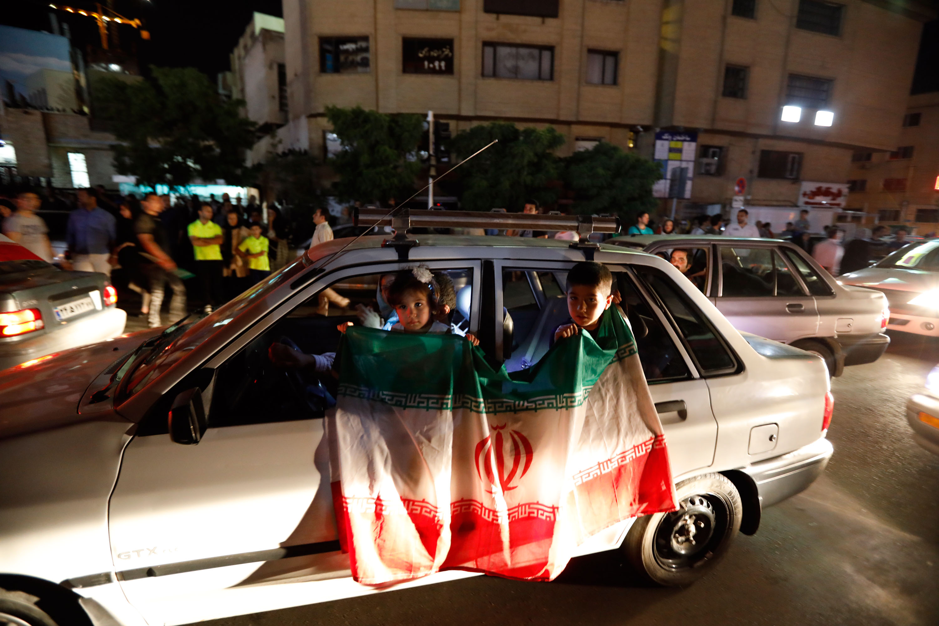 Iranians celebrate on the streets of Tehran early on June 13, 2017, after their national football team won the 2018 World Cup qualifying football match between Iran and Uzbekistan. Iran become the third team assured of a berth in the 2018 World Cup finals along with hosts Russia and Brazil after a 2-0 win over Uzbekistan in Tehran on June 12. / AFP PHOTO / STRINGER (Photo credit should read STRINGER/AFP/Getty Images)