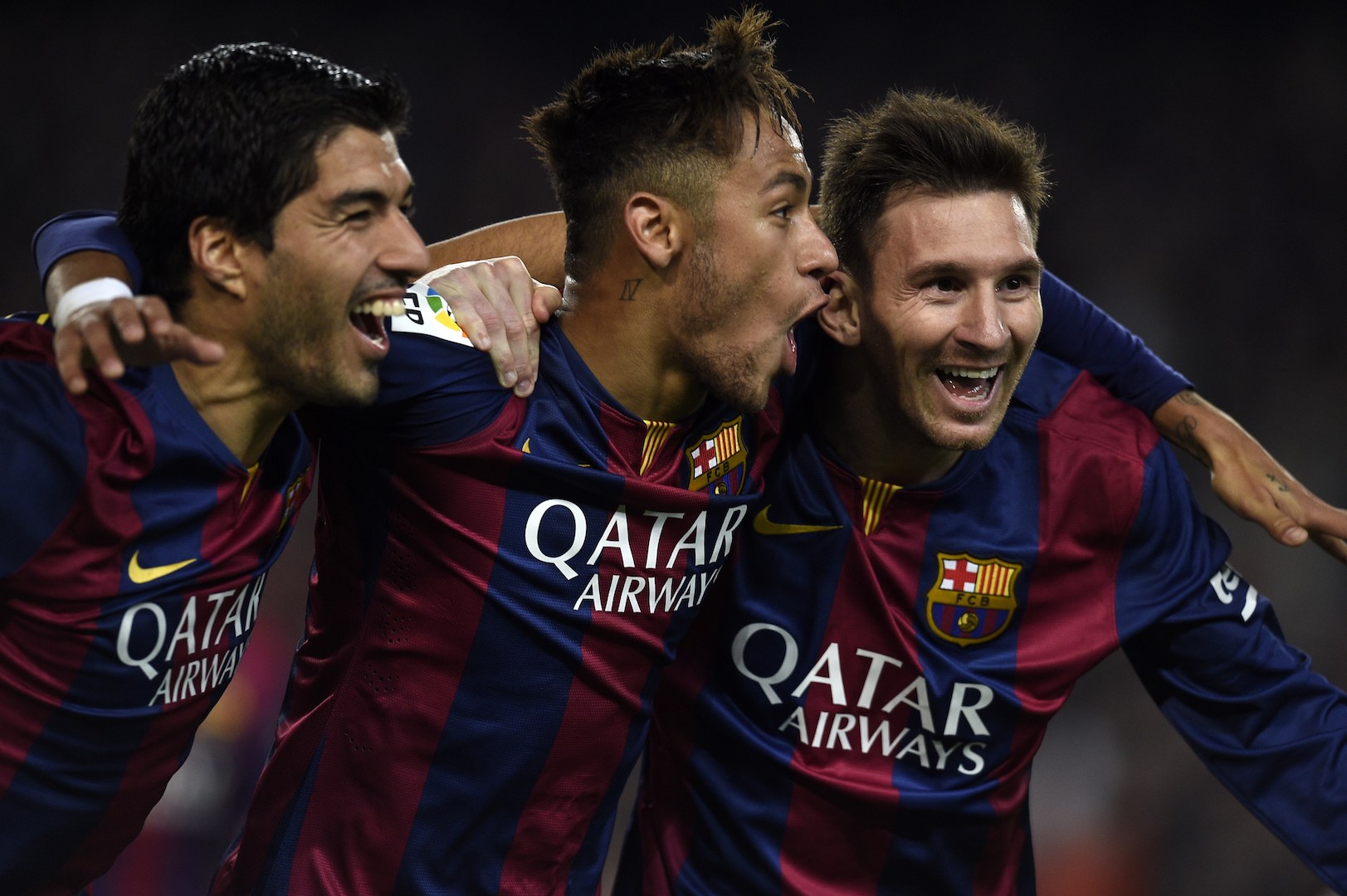 Barcelona's Argentinian forward Lionel Messi, Barcelona's Brazilian forward Neymar da Silva Santos Junior and Barcelona's Uruguayan forward Luis Suarez celebrate during the Spanish league football match FC Barcelona vs Club Atletico de Madrid at the Camp Nou stadium in Barcelona on January 11, 2015. AFP PHOTO/ LLUIS GENE (Photo credit should read LLUIS GENE/AFP/Getty Images)