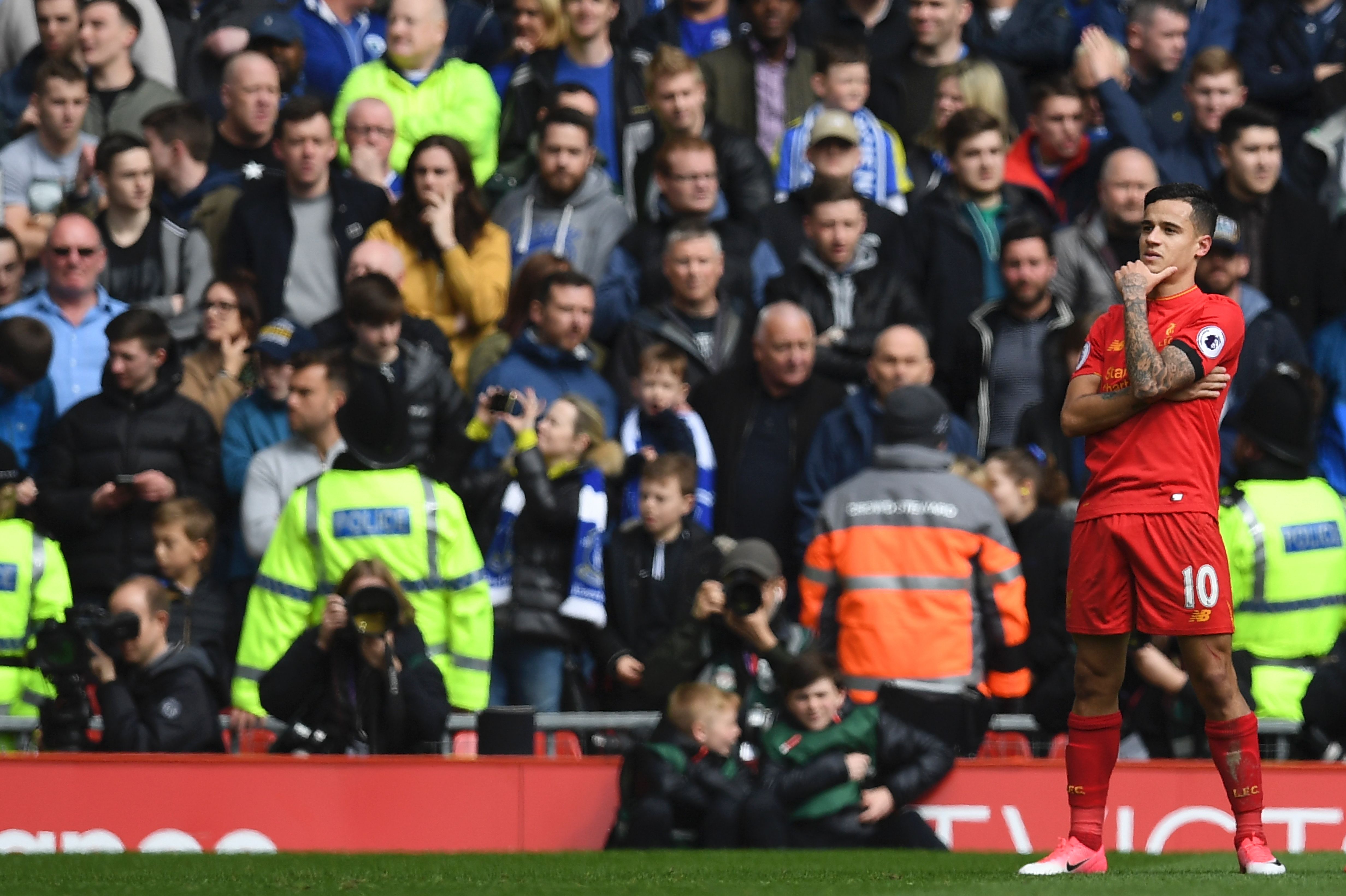 Liverpool's Brazilian midfielder Philippe Coutinho celebrates after scoring their second goal during the English Premier League football match between Liverpool and Everton at Anfield in Liverpool, north west England on April 1, 2017. / AFP PHOTO / Paul ELLIS / RESTRICTED TO EDITORIAL USE. No use with unauthorized audio, video, data, fixture lists, club/league logos or 'live' services. Online in-match use limited to 75 images, no video emulation. No use in betting, games or single club/league/player publications. / (Photo credit should read PAUL ELLIS/AFP/Getty Images)