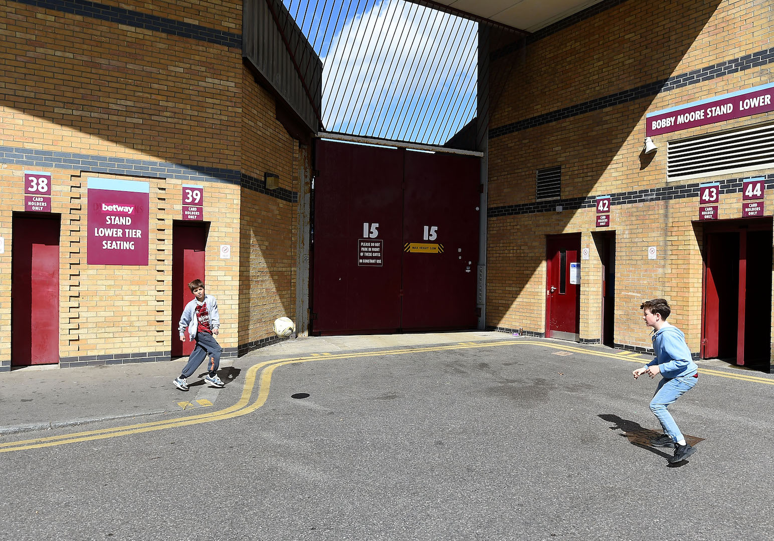 LONDON, ENGLAND - APRIL 11: Boys play football outside the stadium prior to the Barclays Premier League match between West Ham United and Stoke City at Boleyn Ground on April 11, 2015 in London, England. (Photo by Tom Dulat/Getty Images)