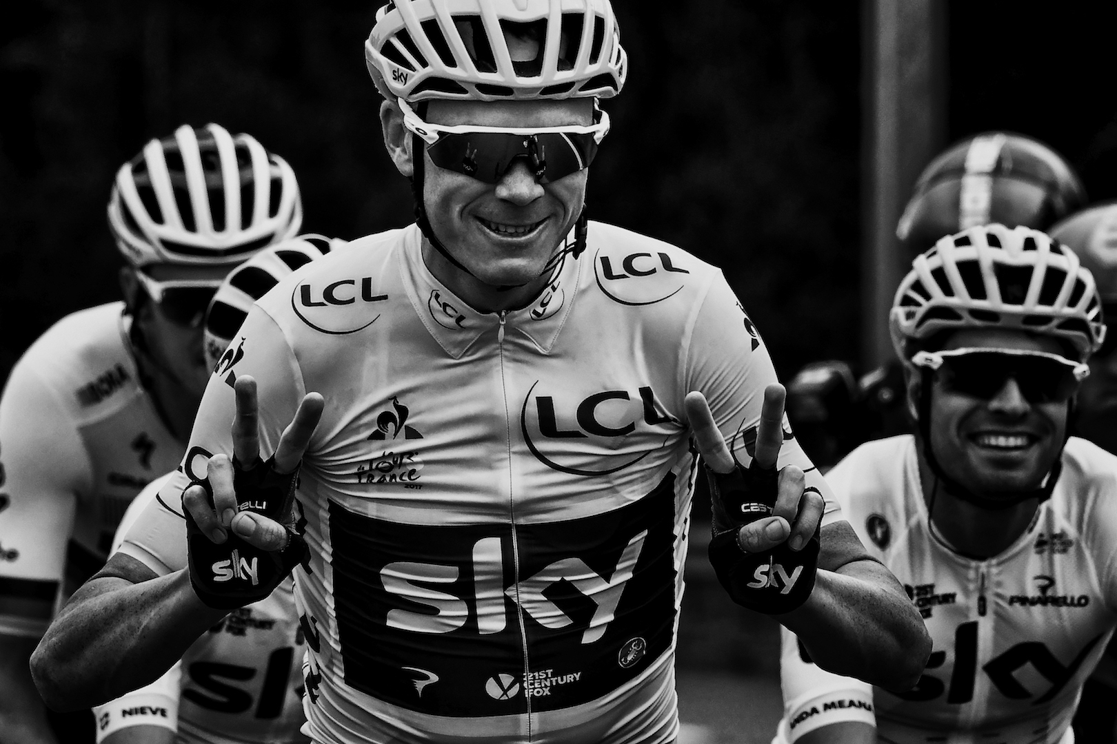 BLACK AND WHITE VERSION Great Britain's Christopher Froome (C) wearing the overall leader's yellow jersey flashes victory signs next to Spain's Mikel Landa during the 103 km twenty-first and last stage of the 104th edition of the Tour de France cycling race on July 23, 2017 between Montgeron and Paris Champs-Elysees. / AFP PHOTO / JEFF PACHOUD (Photo credit should read JEFF PACHOUD/AFP/Getty Images)