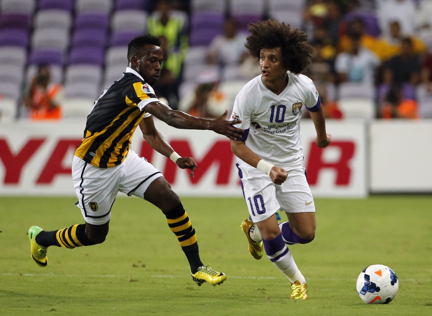 UAE's Al-Ain's midfielder Omar Abdulrahman (R) dribbles past Saudi's Al-Ittihad forward Fahad Al-Muwallad (L) during their AFC Champions League football match on August 19, 2014 at the Sheikh Hazza Bin Zayed Stadium in al-Ain. AFP PHOTO /KARIM SAHIB (Photo credit should read KARIM SAHIB/AFP/Getty Images)