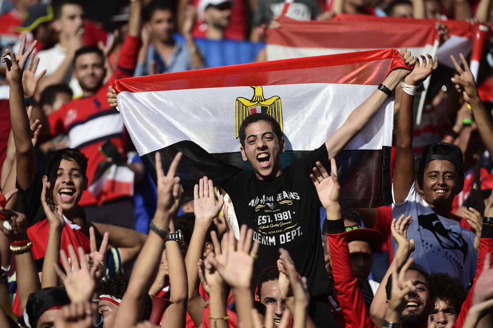 Egyptian fans cheer for their national team before the FIFA World Cup 2018 qualification football match between Egypt and Uganda at the Borg al-Arab Stadium near Alexandria on September 5, 2017. / AFP PHOTO / KHALED DESOUKI (Photo credit should read KHALED DESOUKI/AFP/Getty Images)